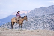 Flitner Ranch, Shell, WY - young cowboy on horse with pink hills
